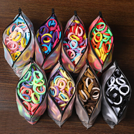 Paquete de 100 ligas elásticas sin costuras para el cabello de niños; diseño tipo toalla suave que no daña el pelo; colores vivos tipo caramelo; alta elasticidad.